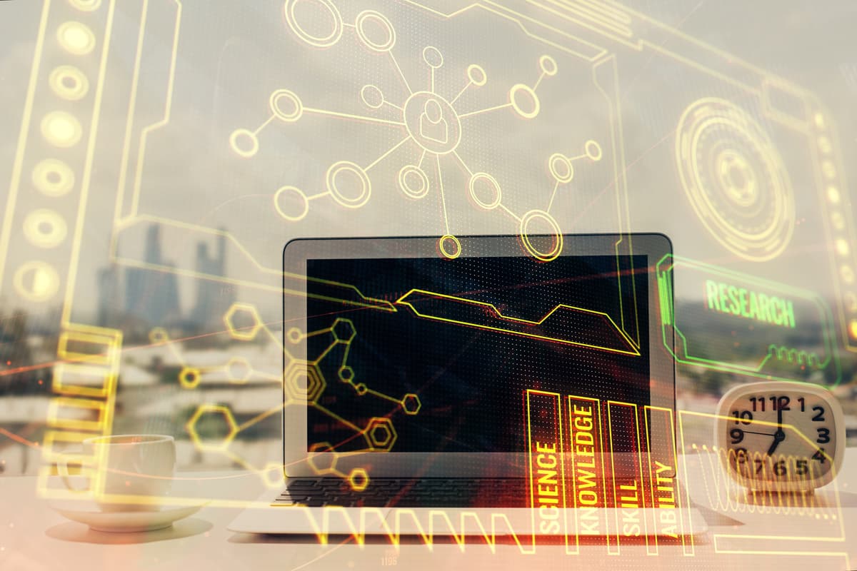A laptop on a desk with a cup, papers, and a clock, overlaid with futuristic digital graphics, including charts, science, research, and technology icons, suggesting innovation or data analysis. | Betechit.com