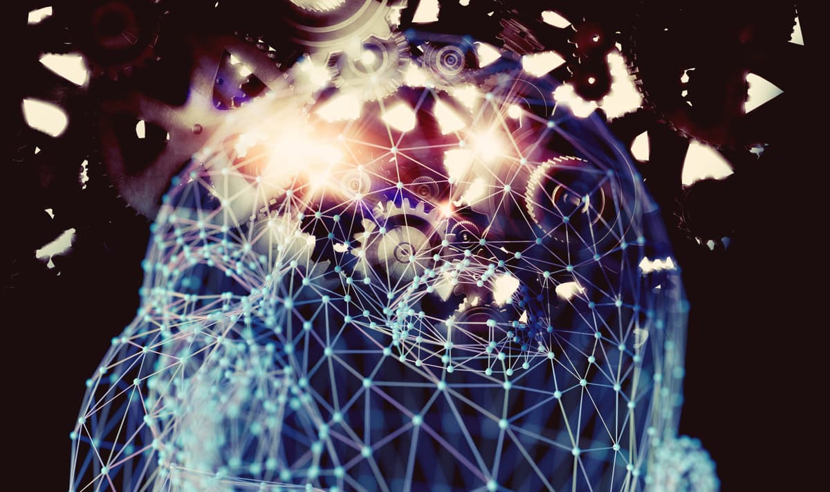 A digital illustration of a human head made from interconnected glowing lines and nodes, overlaid with gears and cogs, symbolizing artificial intelligence and technology integration. | Betechit.com