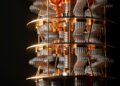 A close-up view of a quantum computer’s intricate interior, showing gold and silver wiring, coils, and circular layers against a black background. | Betechit.com
